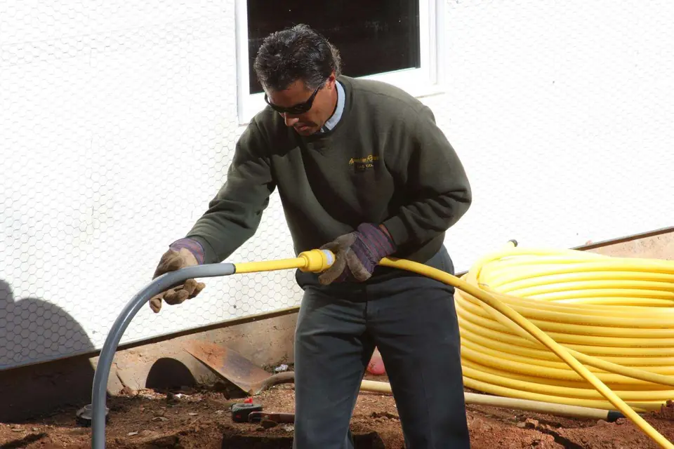 Technician running yellow underground gas line