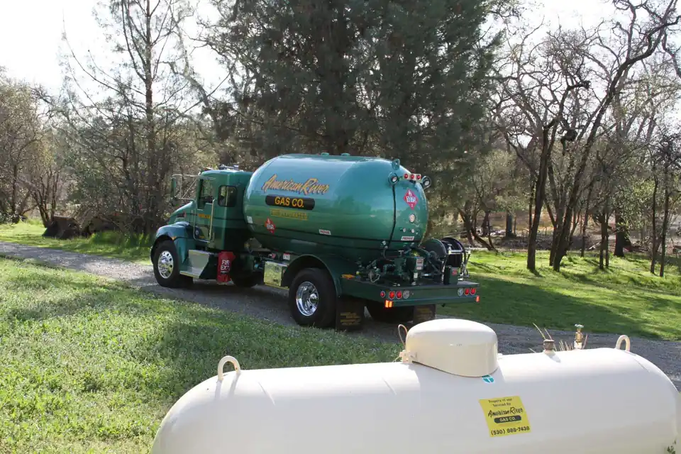 Delivery truck parked beside a customer's propane tank